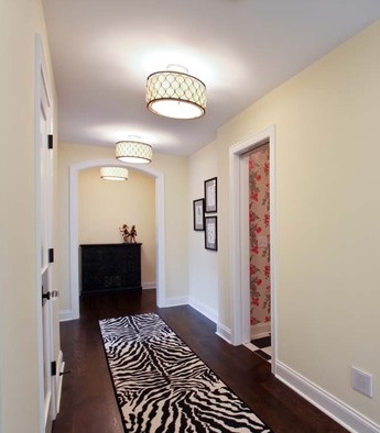 Flush mount lighting combines a compact profile with a decorative appearance that's great for dressing up a hallway with low ceilings (by REFINED LLC)