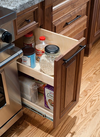 Pull out cabinets allow instant, easy access to items and help minimize clutter (by Old World Kitchens & Custom Cabinets, photo by Bob Young)