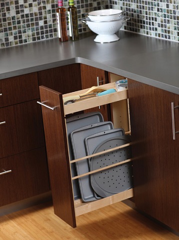 Slim pull out cabinets can fit in spaces that traditional cabinets can't, and are much more efficient for odd shaped items (by Dura Supreme Cabinetry)
