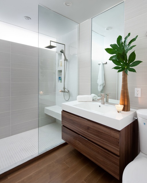 Shower screens shine in small bathrooms, where they keep the space feeling open, and in large ones, where they act as a minimalist barrier between different parts of the bathroom (by Paul Kenning Stewart Design)