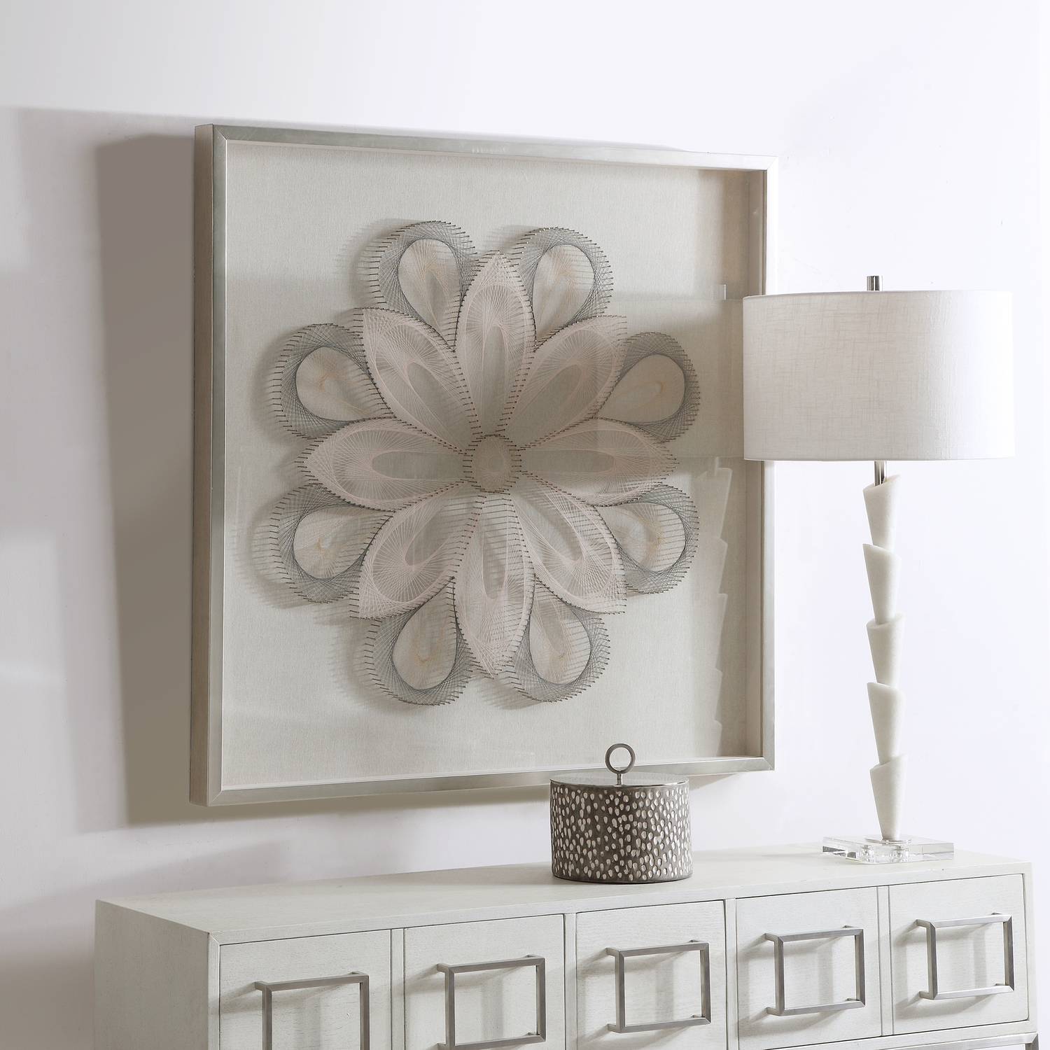 Uttermost Shadow Box Boxes and Bookends This Statement Making Shadow Box Features 3-dimensional Layered String Art, Hand Threaded Around Individually Hammered Pin Nails In Shades Of Slate Gray, Tan And Blush, Over A Neutral Linen Backing With A Silver Leaf Frame.